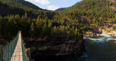 See One Of The State's Largest Waterfalls From This Swinging Bridge In Montana
